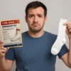 Confused man holding a Tube Sock Emergency Kit prank mail label and a white tube sock, reacting to realistic parody packaging.