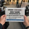 Golf Game Intervention Kie Prank Mail A person holding a golf game intervention kit prank in a golf cart at a golf course