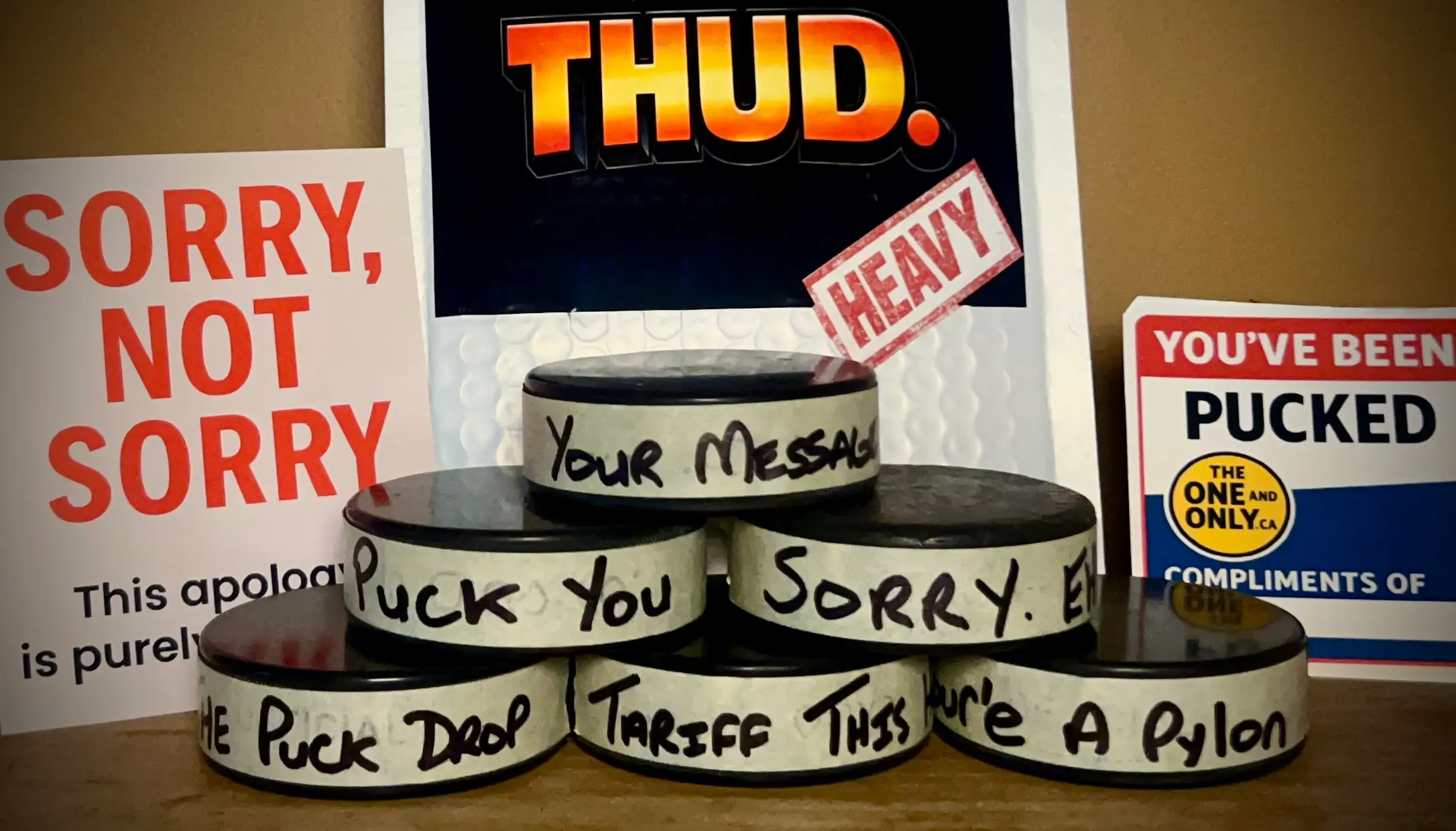 Close up of custom message hockey pucks from TheOneAndOnly.ca