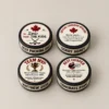 The Puck Drop™ Custom Hockey Pucks (2) Four personalized hockey pucks with custom printed labels on a warm neutral background.