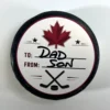 Top view of a personalized hockey puck gift with custom To and From label, perfect for birthdays, coaches, teammates, and hockey fans.