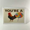 You are a rooster lollipop prank mail gag gift box with rooster image and colorful lollipop on the label