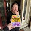 Woman laughing after receiving an embarrassing secondhand sex toys prank package