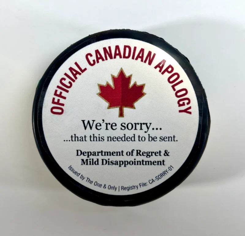 Official Canadian Apology custom hockey puck with humorous apology message.