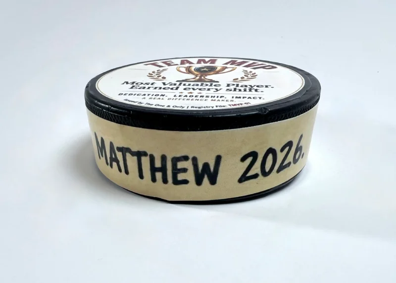 Custom Team MVP hockey puck award with personalized side message.