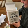 Box contains nothing gag gift reaction Man opening an empty This Box Contains Nothing gag gift