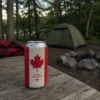 Canadian flag beer can sleeve on a campsite picnic table beside a tent