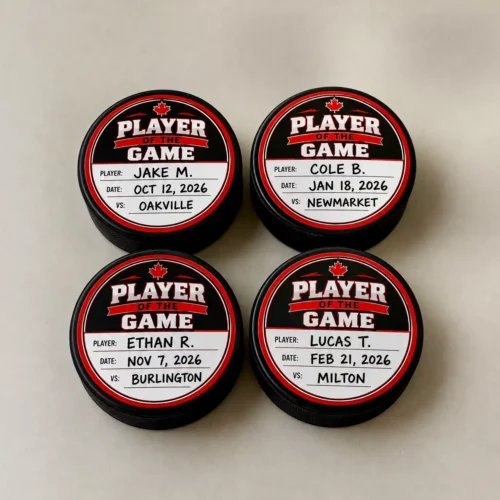 Four Player of the Game hockey puck awards with player names dates and opponents