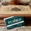 The Fumble fantasy football last place gift packaging on a white bubble mailer