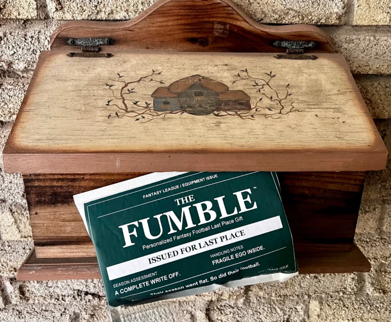 The Fumble fantasy football last place gift packaging on a white bubble mailer